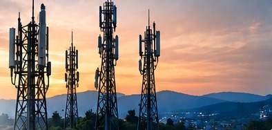 Telecom antenna towers against an evening sky